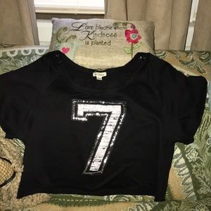 Woman’s size L half shirt “7”.